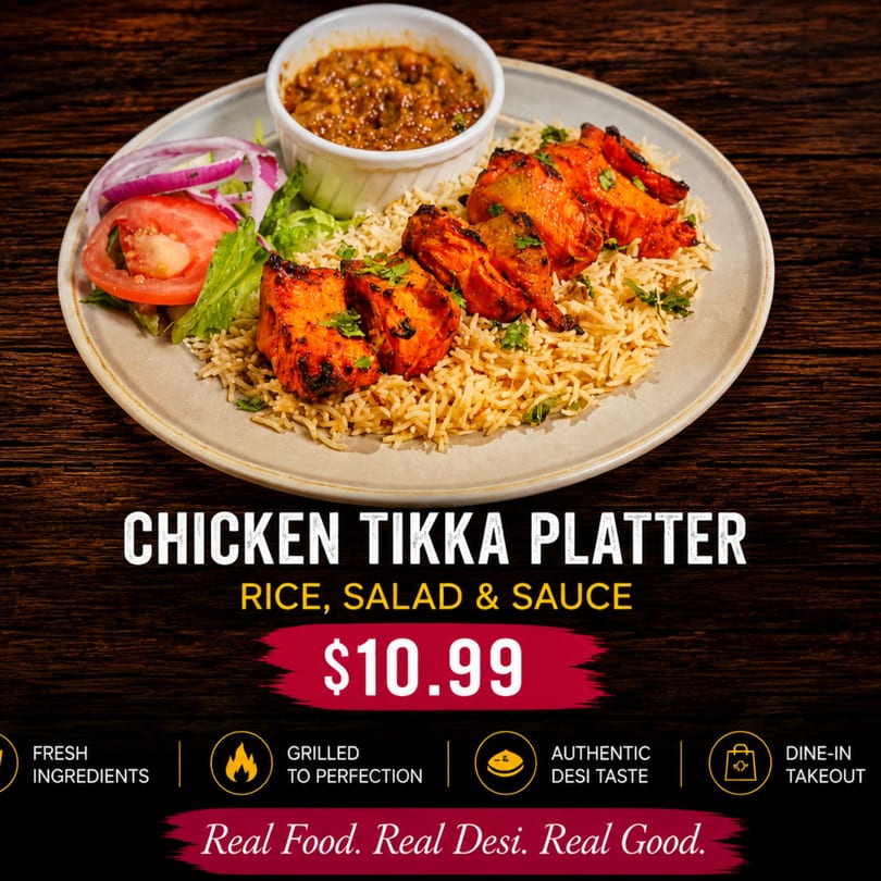 A chicken tikka platter with rice, salad, and sauce on a rustic wooden table.